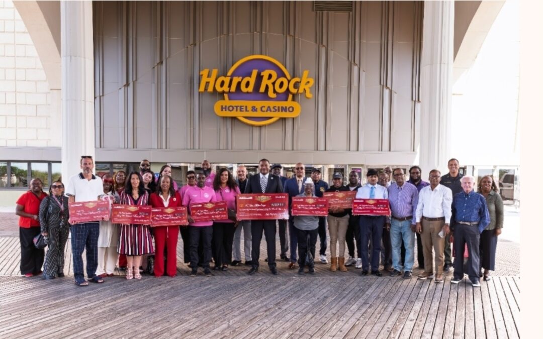 Representatives of Atlantic City community organizations gather with ceremonial checks outside Hard Rock Hotel & Casino Atlantic City.