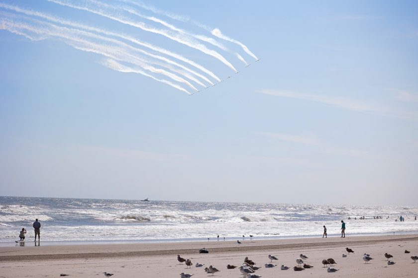 Aerobatic planes fly in formation above the Ocean City beach